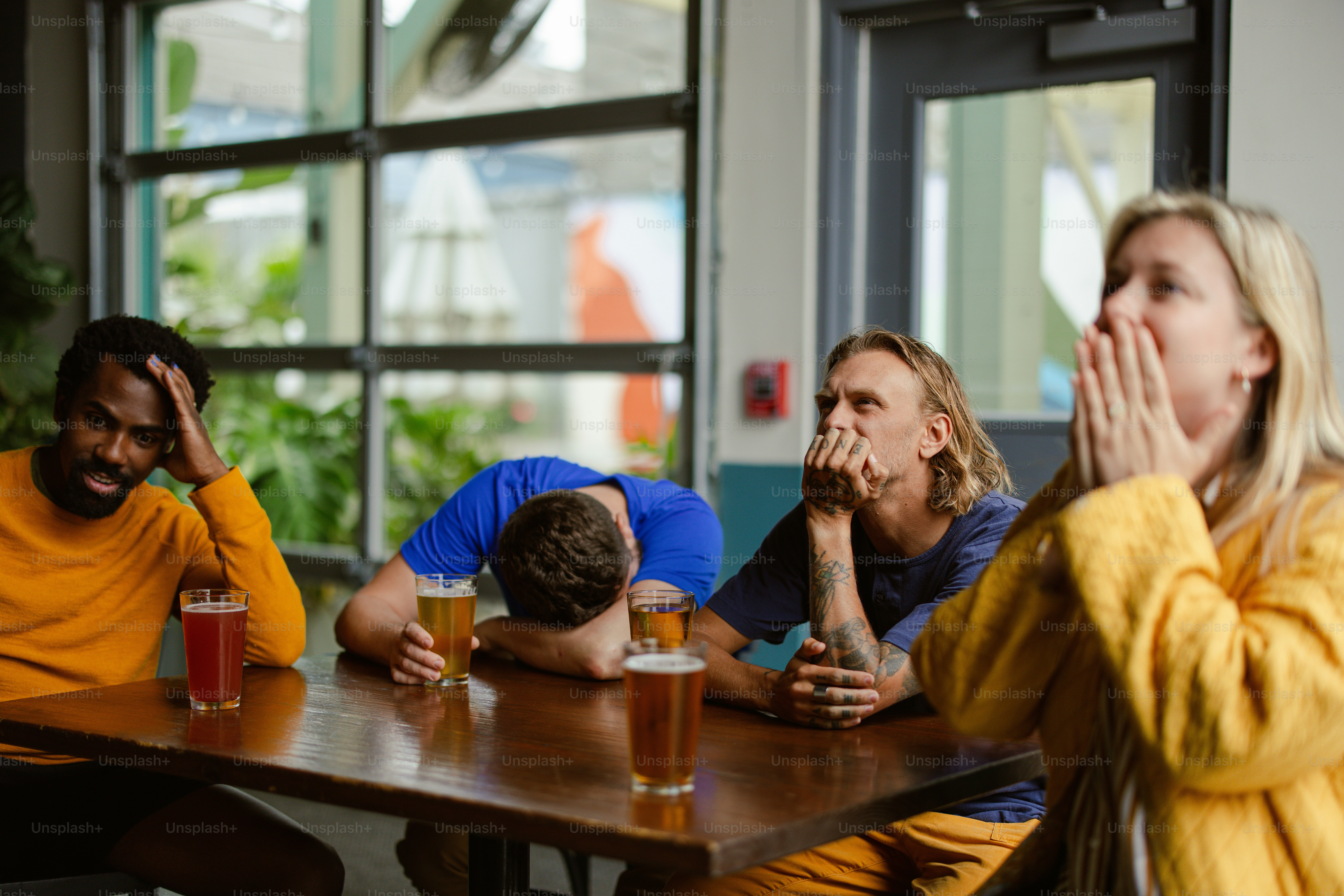 a group of people sitting around a wooden table