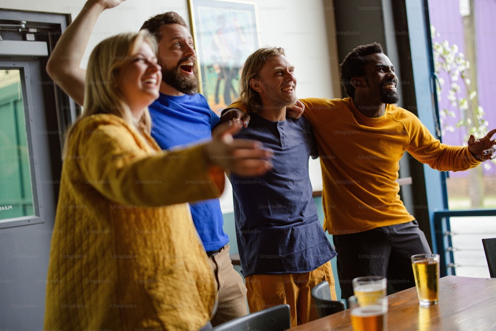 a group of people standing around a wooden table