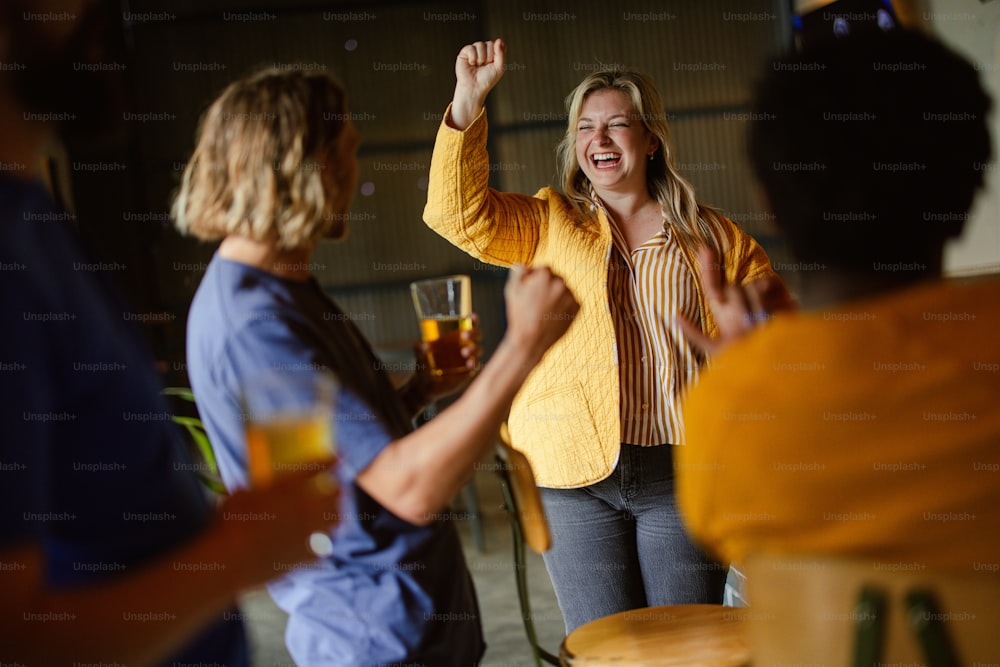 a woman in a yellow jacket is dancing with other people