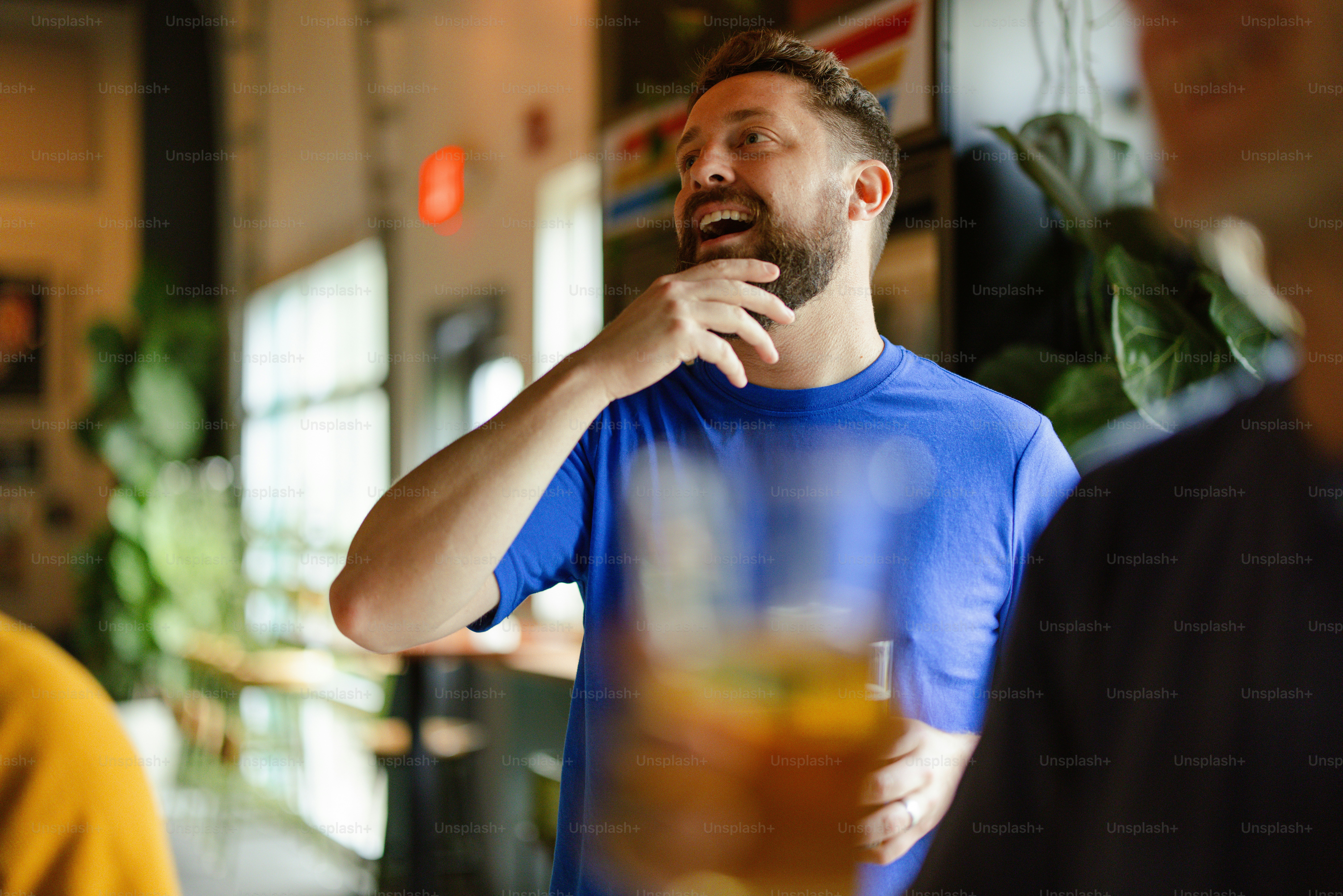 a man in a blue shirt is looking up at something