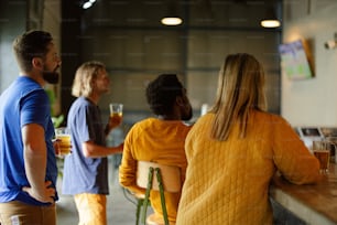 a group of people standing around a bar