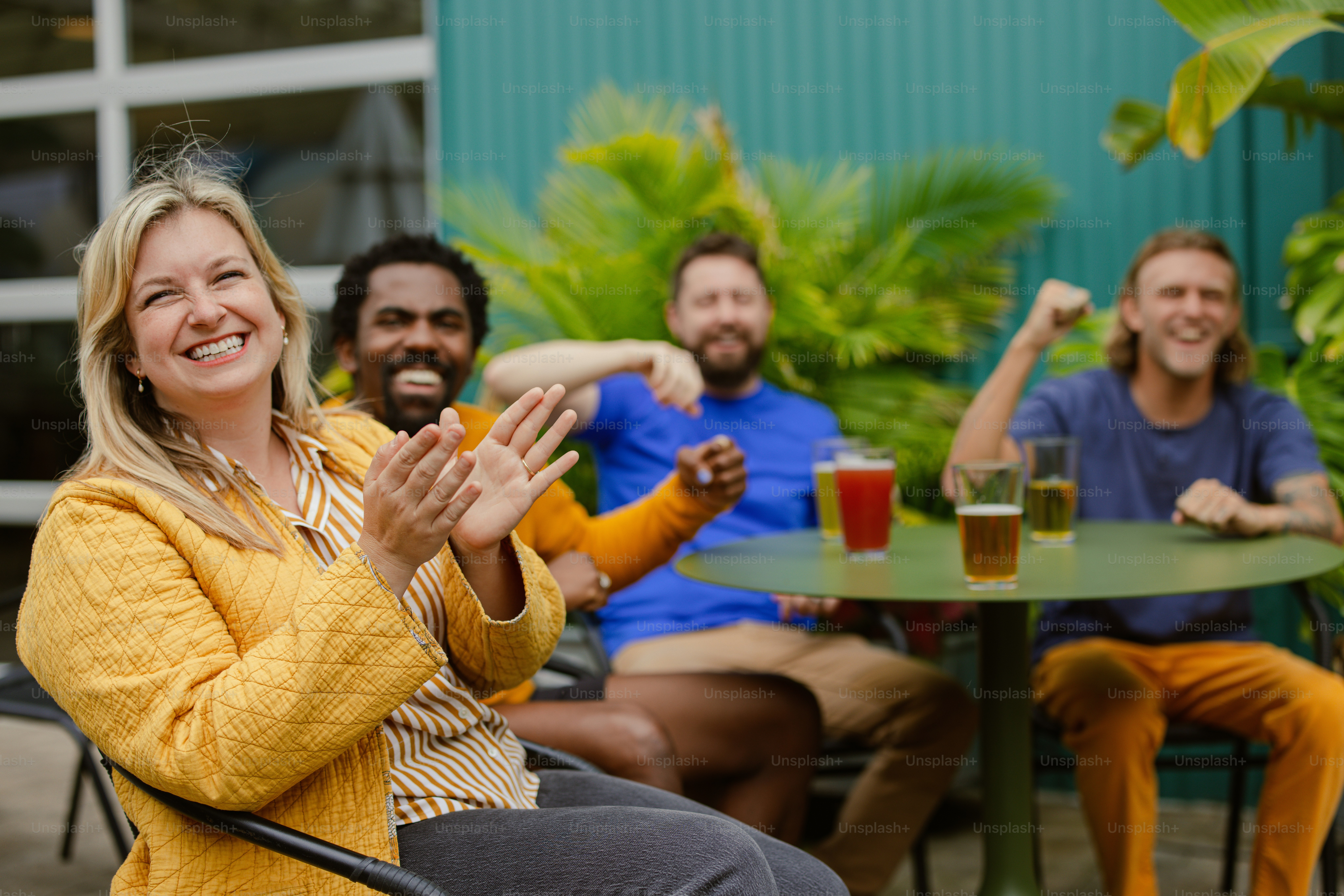 a group of people sitting around a table with drinks