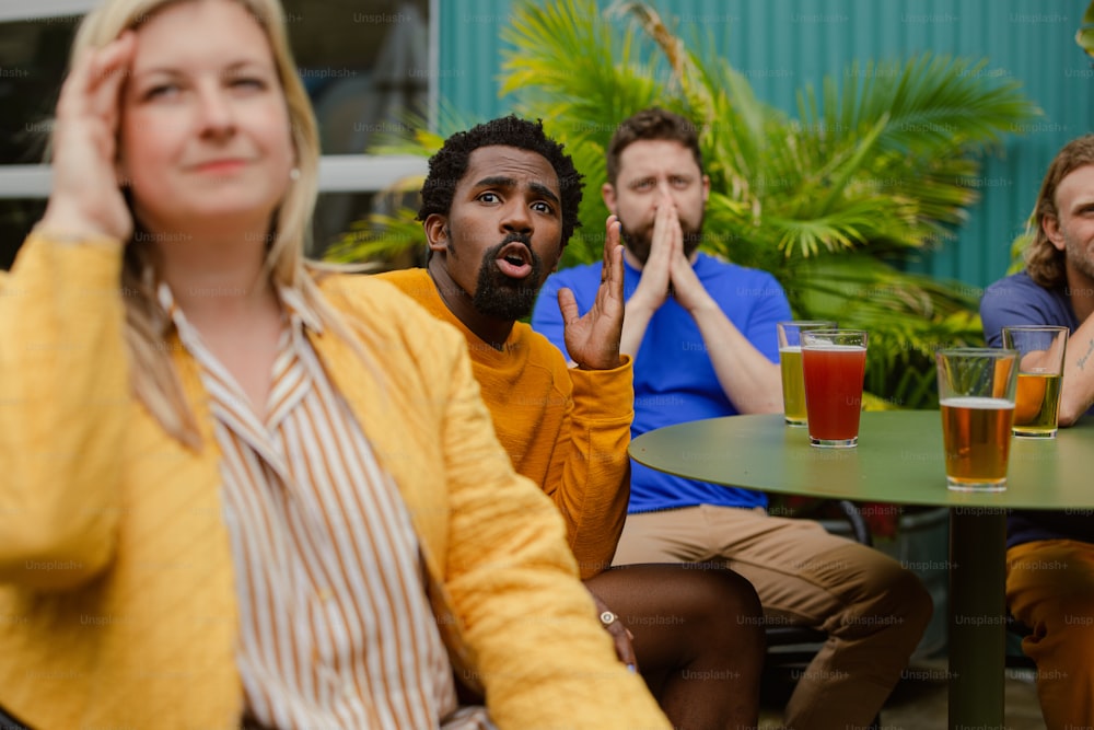 a group of people sitting around a table with drinks