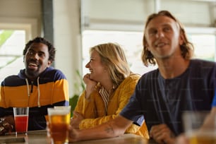 a group of people sitting around a table with drinks