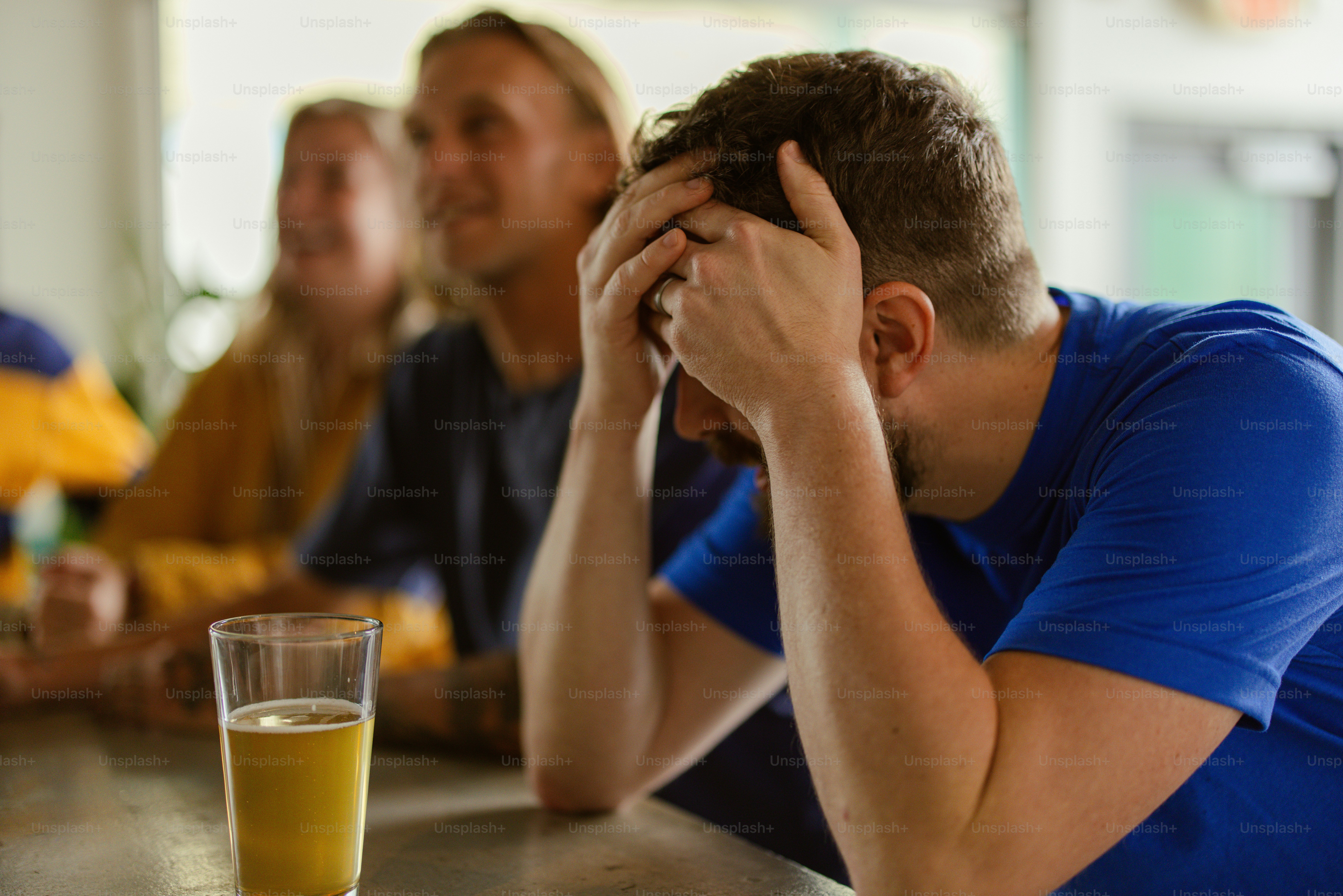 a group of people sitting at a table with a glass of orange juice