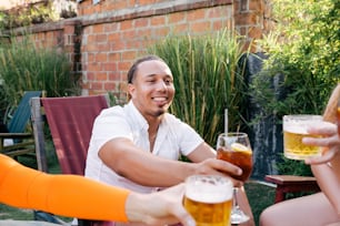 Un grupo de personas sentadas alrededor de una mesa con cervezas