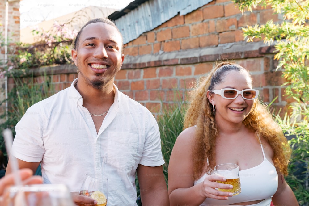a man and a woman holding glasses of beer
