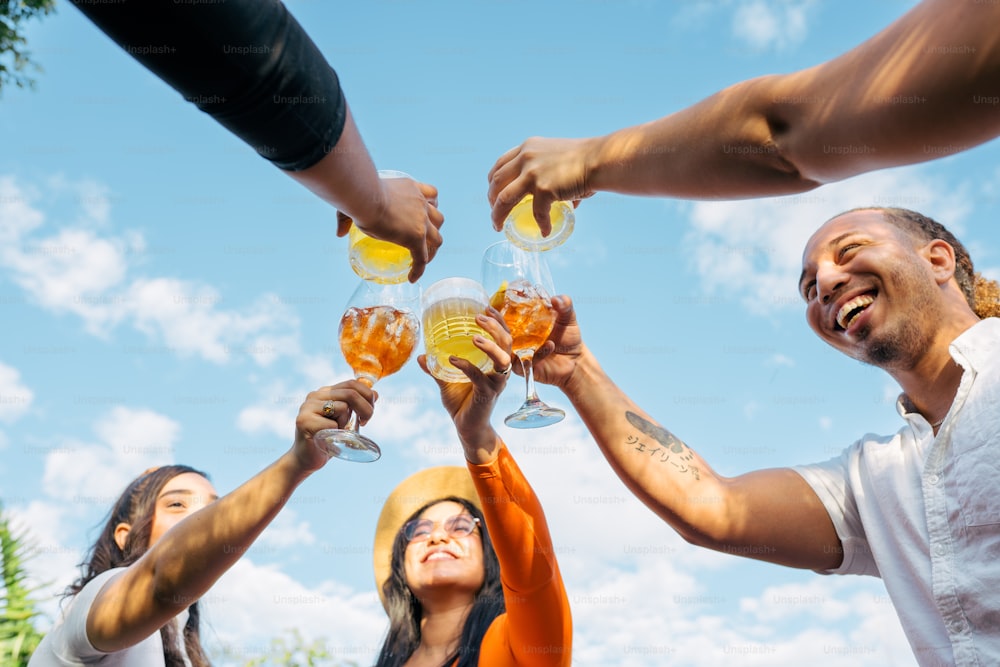 a group of people raising their glasses in the air
