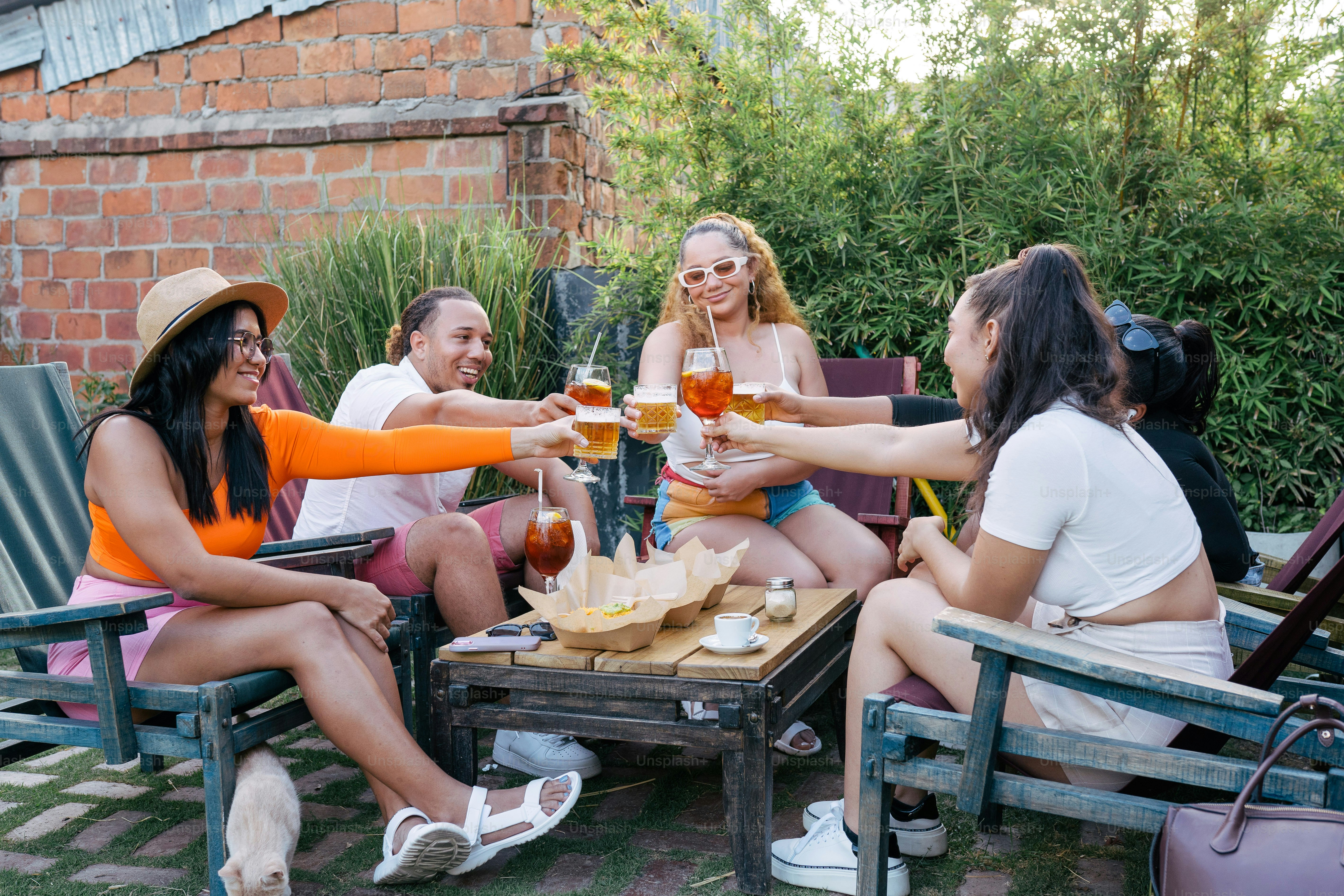 Eine Gruppe von Frauen, die um einen Tisch sitzen und Bier trinken