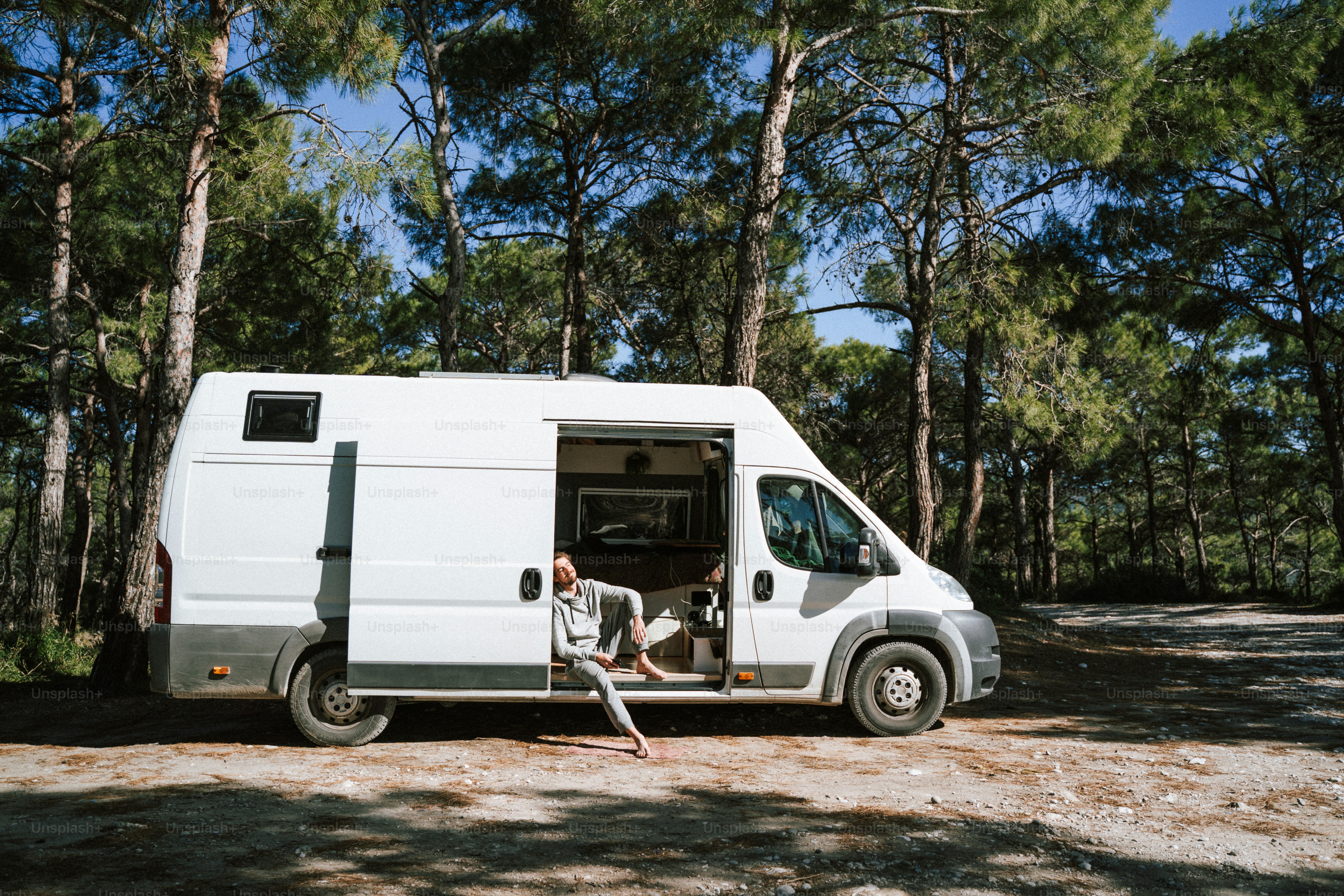 a man sitting in the back of a white van