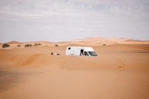 a van is parked in the middle of the desert