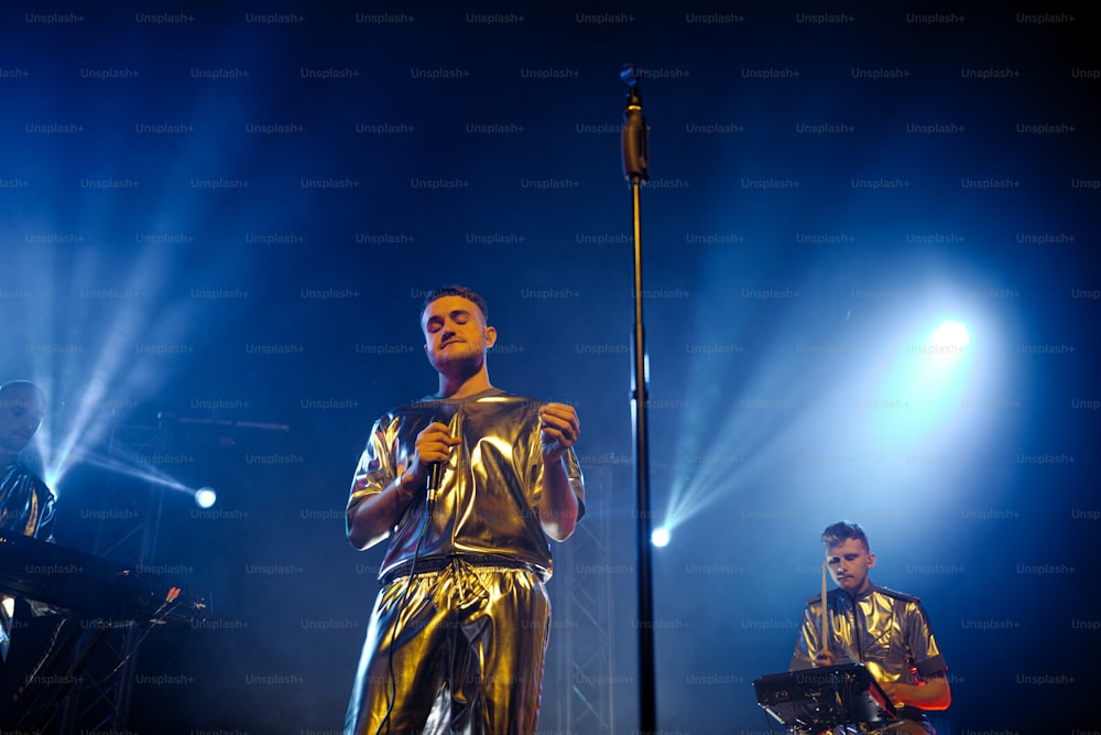 a couple of men standing on top of a stage