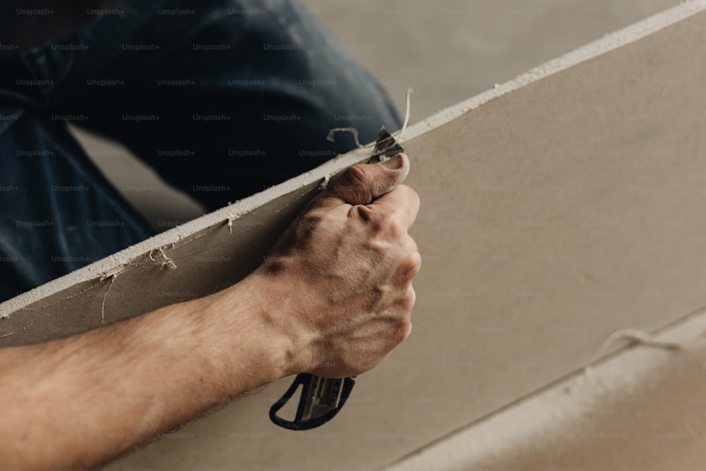 a person holding a piece of concrete with their hands