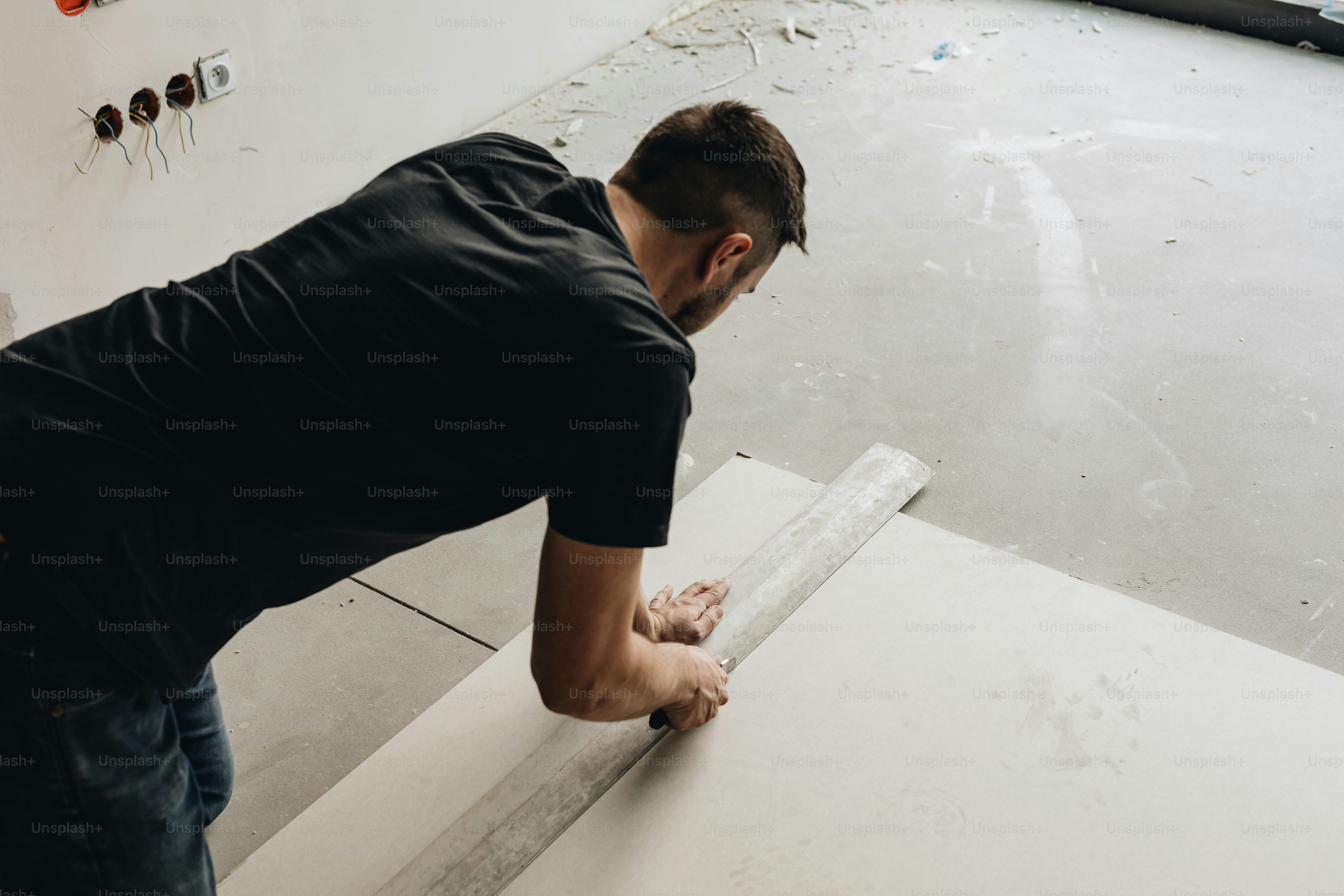 a man working on a piece of white paper