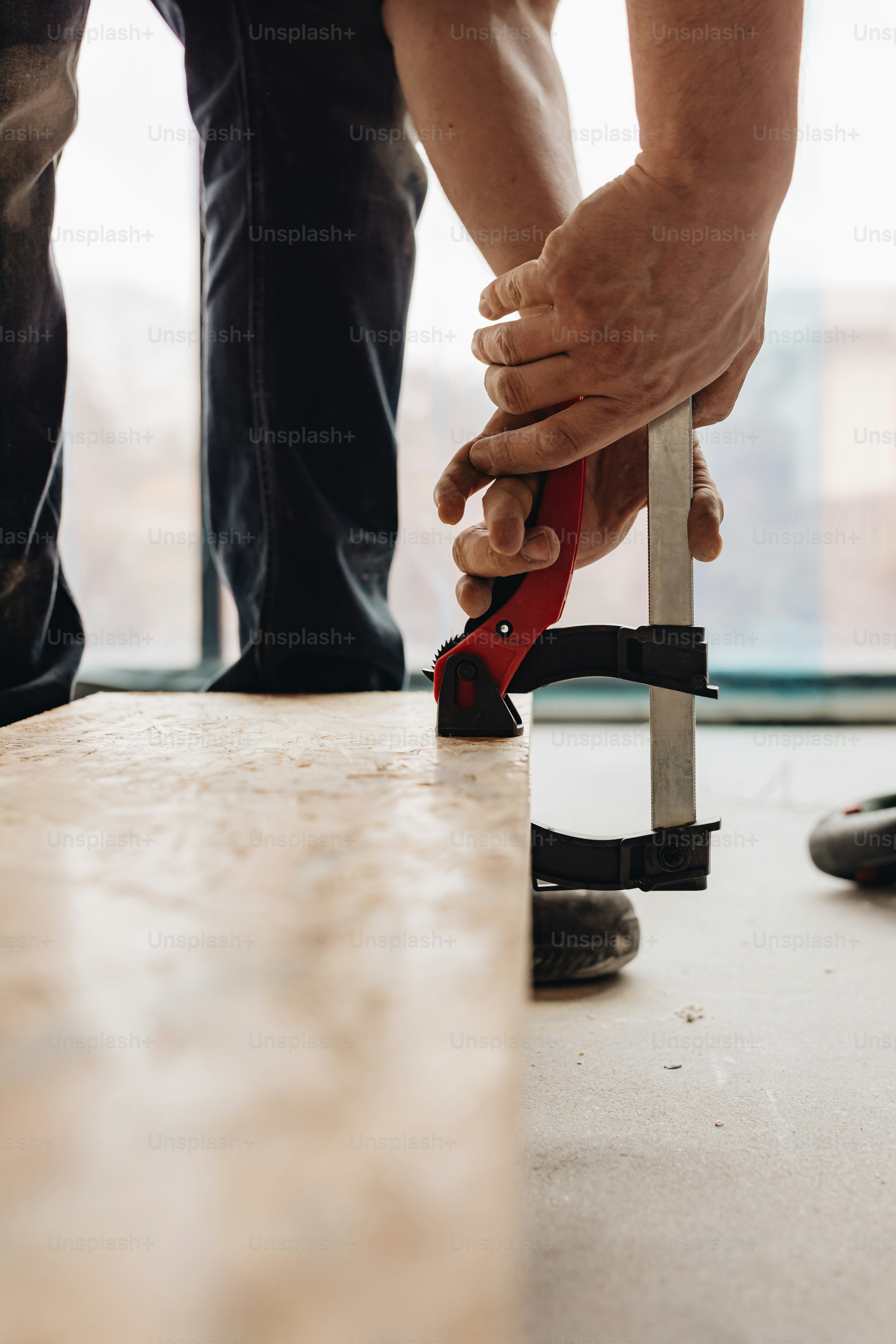 a pair of hands holding a pair of pliers