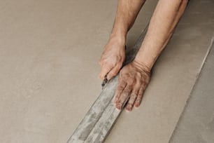 a man is holding onto a piece of wood