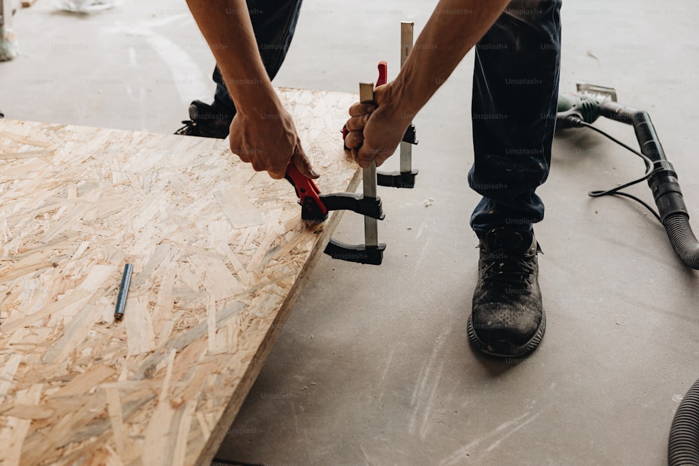 a man is working on a piece of wood