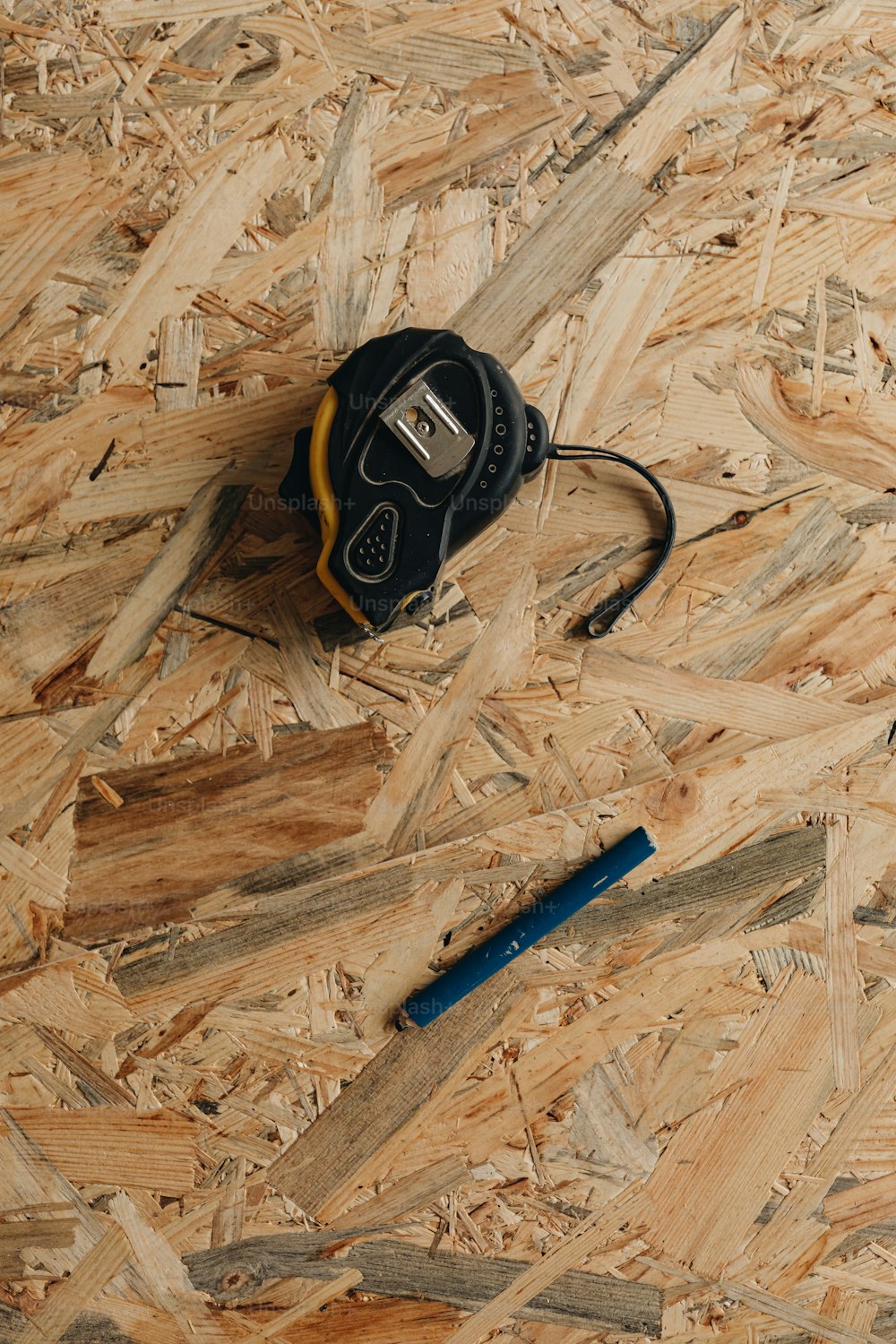 a pair of scissors and a tape measure on a wooden floor