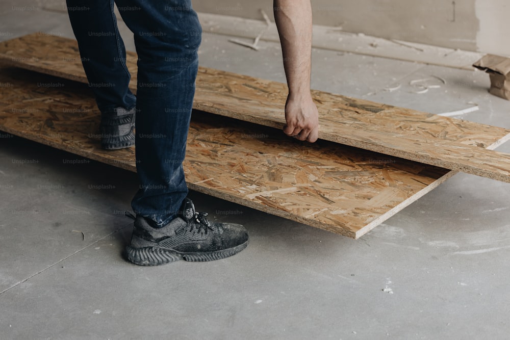 a person standing on a piece of plywood