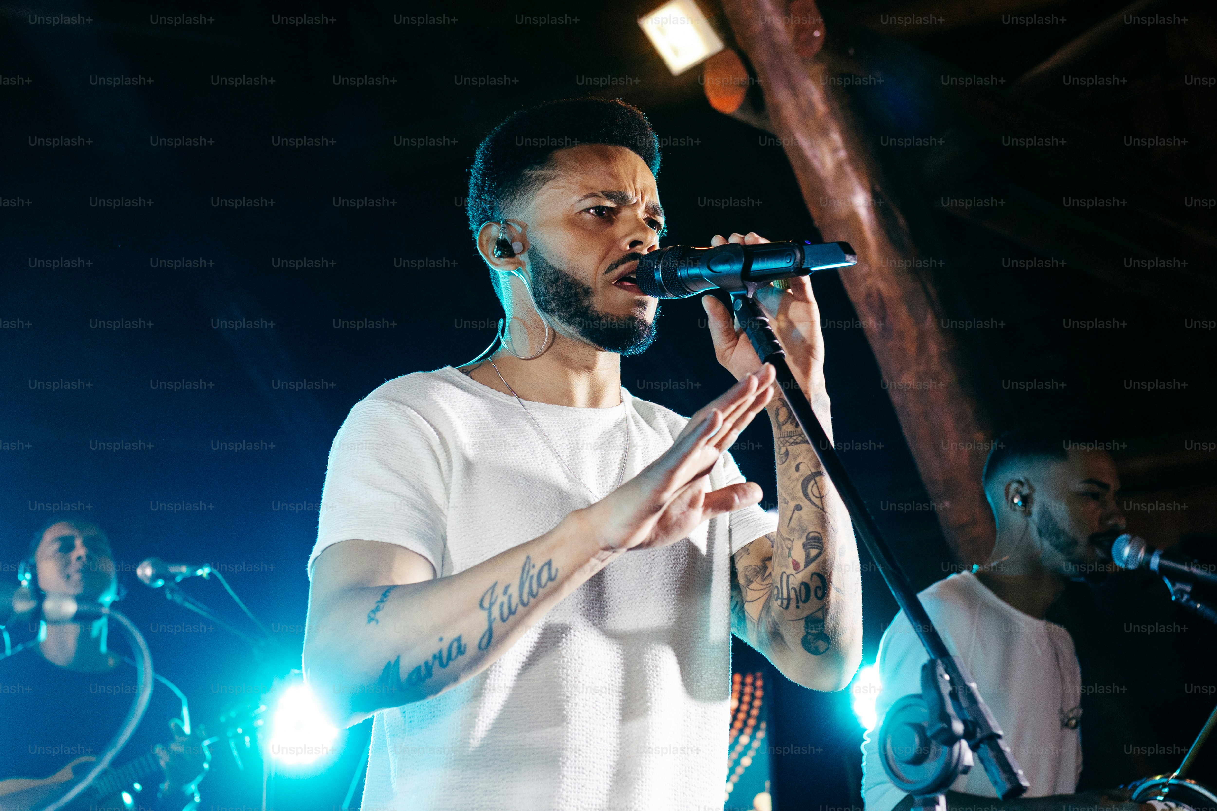 a man standing in front of a microphone on a stage