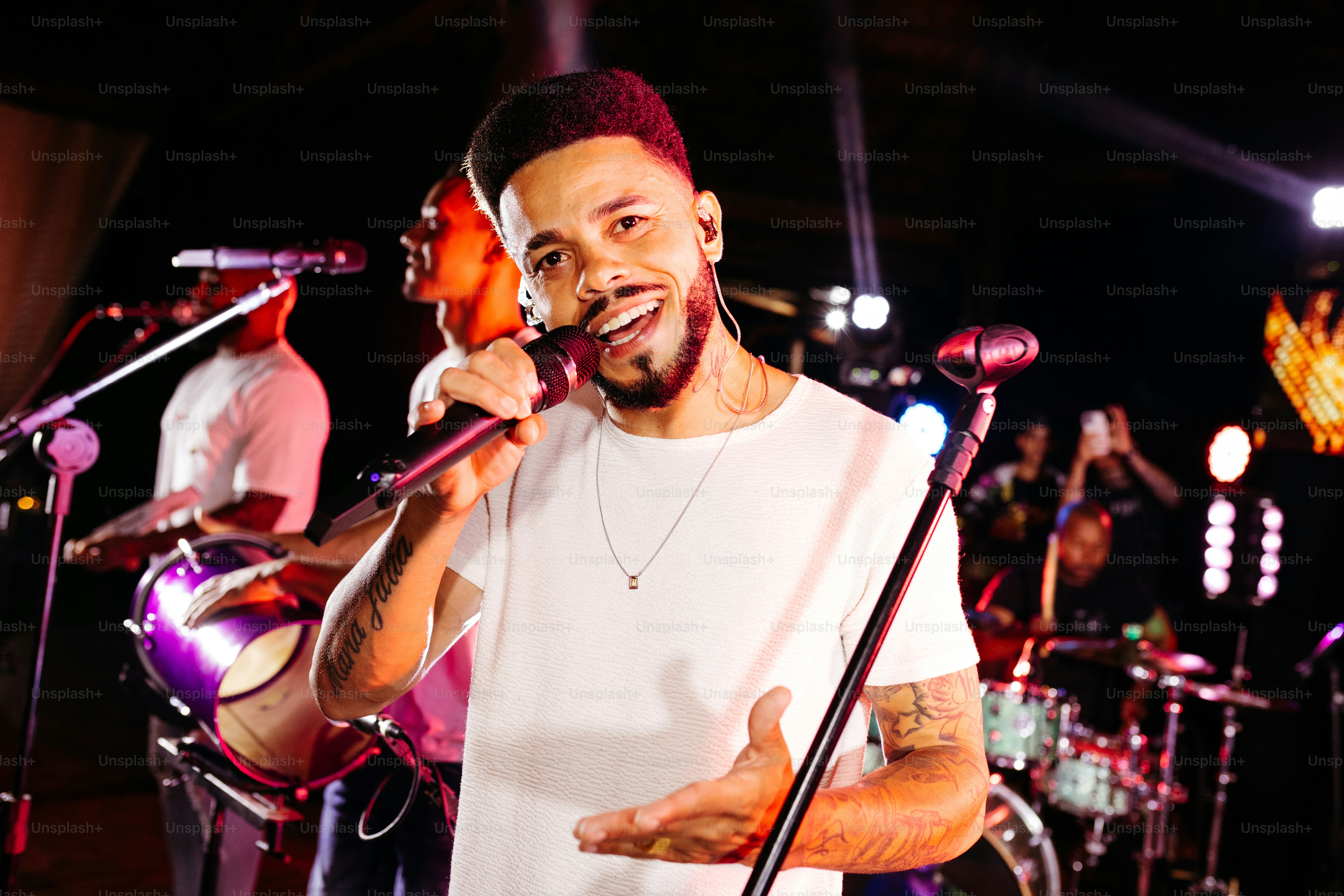 a man with a beard singing into a microphone