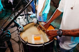 a man is playing a drum set on a stage