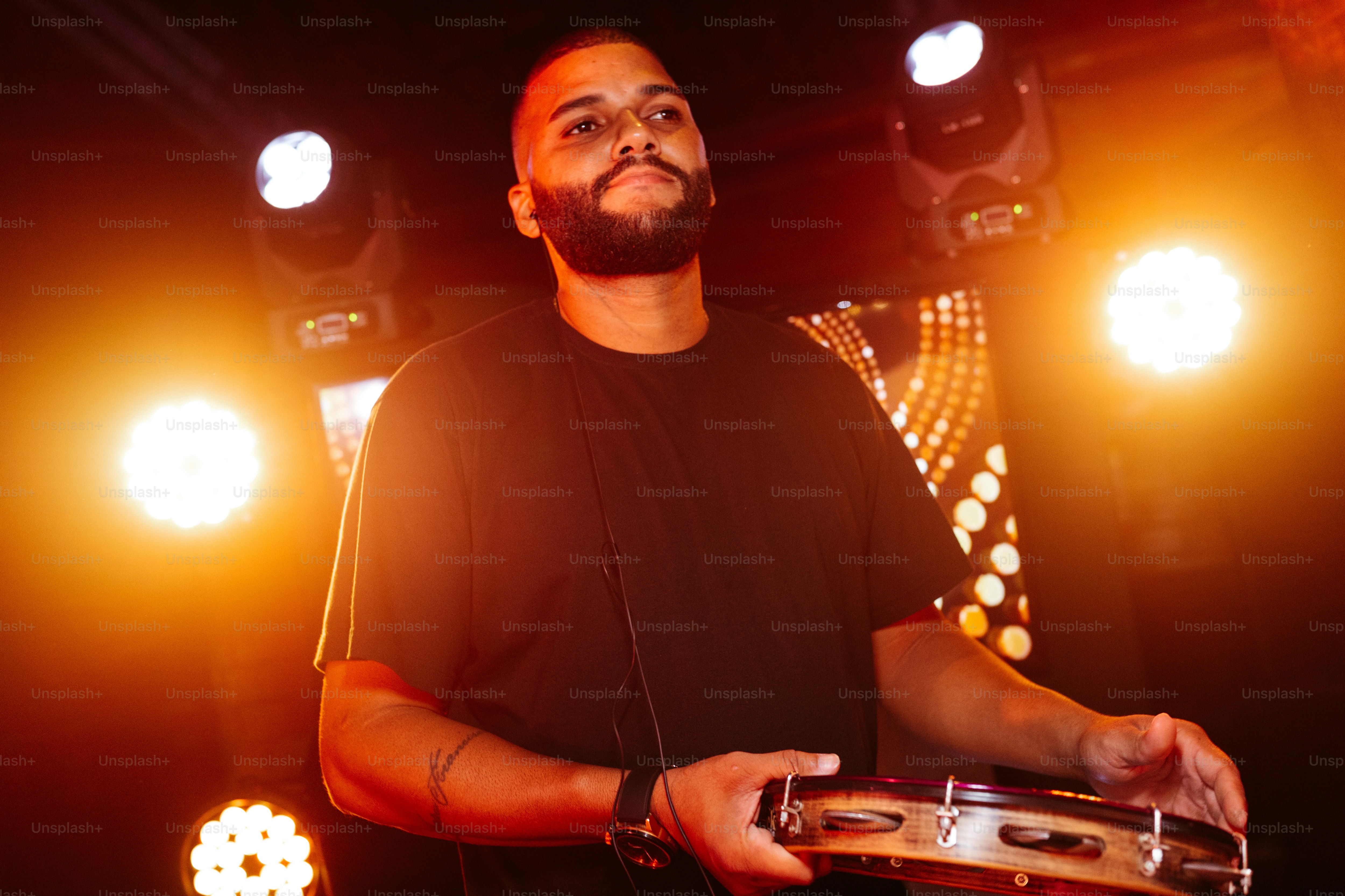 a man standing in front of a stage holding a musical instrument