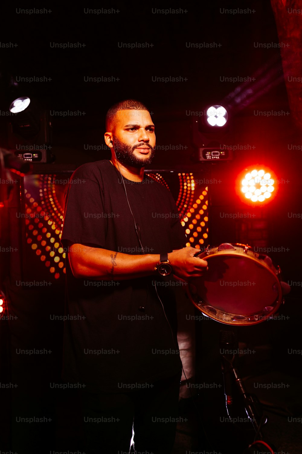a man standing in front of a drum set