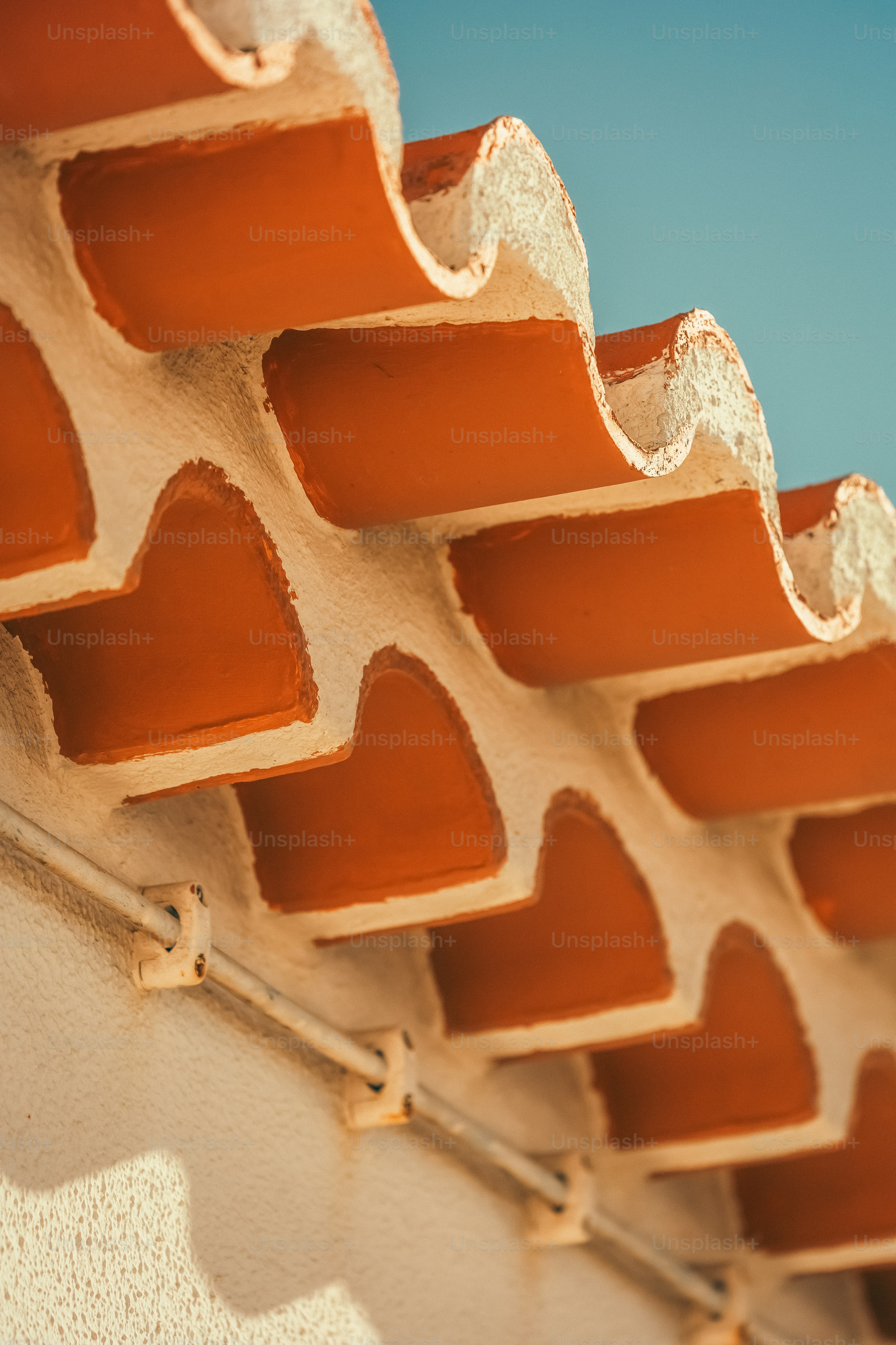 a close up of a roof with a sky in the background