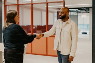 a man and woman shaking hands in an office