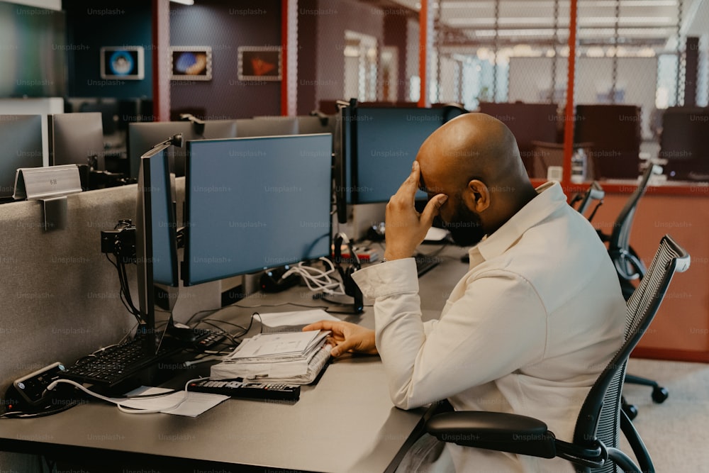 a man sitting at a desk in an office