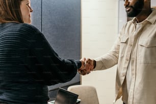 a man and a woman shaking hands in an office