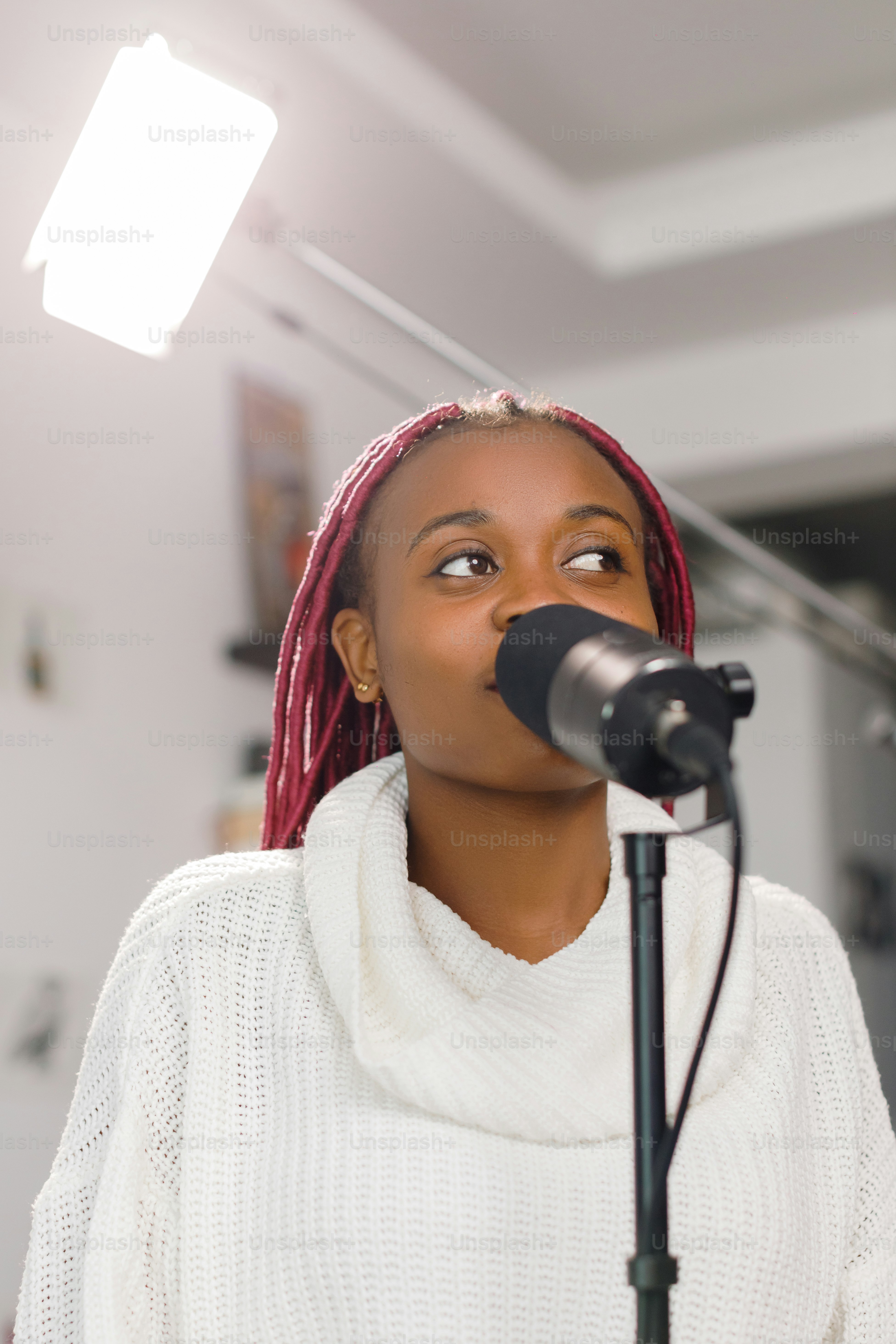 a woman standing in front of a microphone