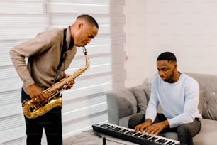 a man playing a keyboard and a man playing a saxophone
