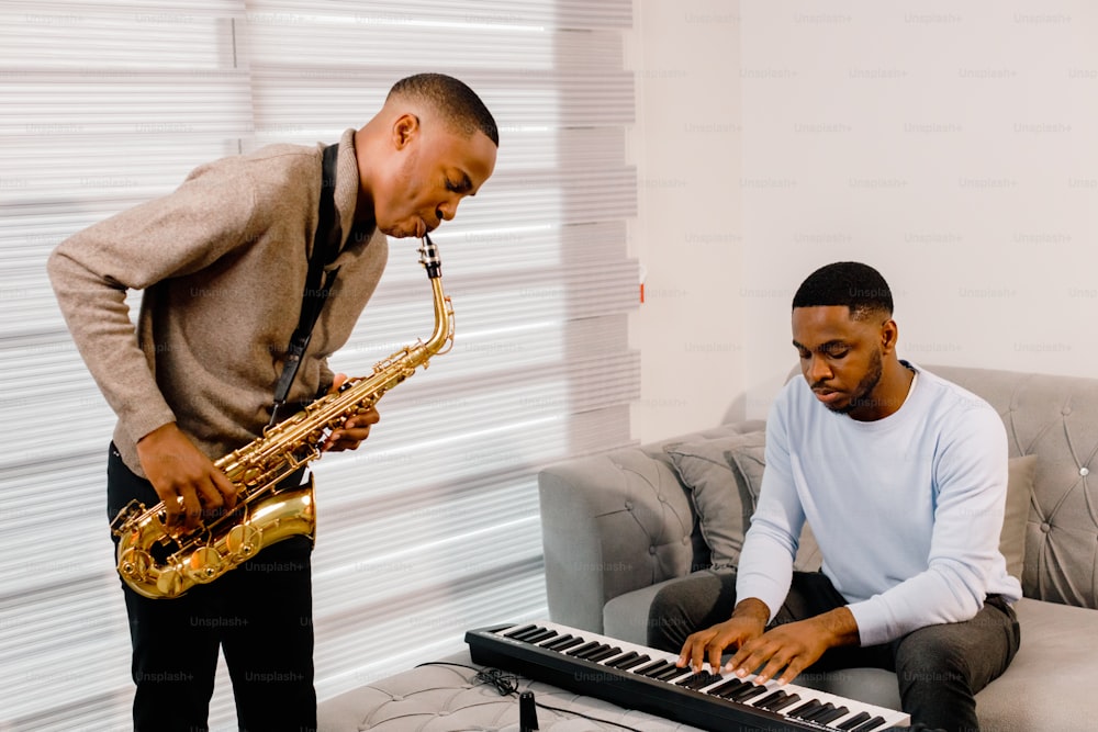 a man playing a keyboard and a man playing a saxophone