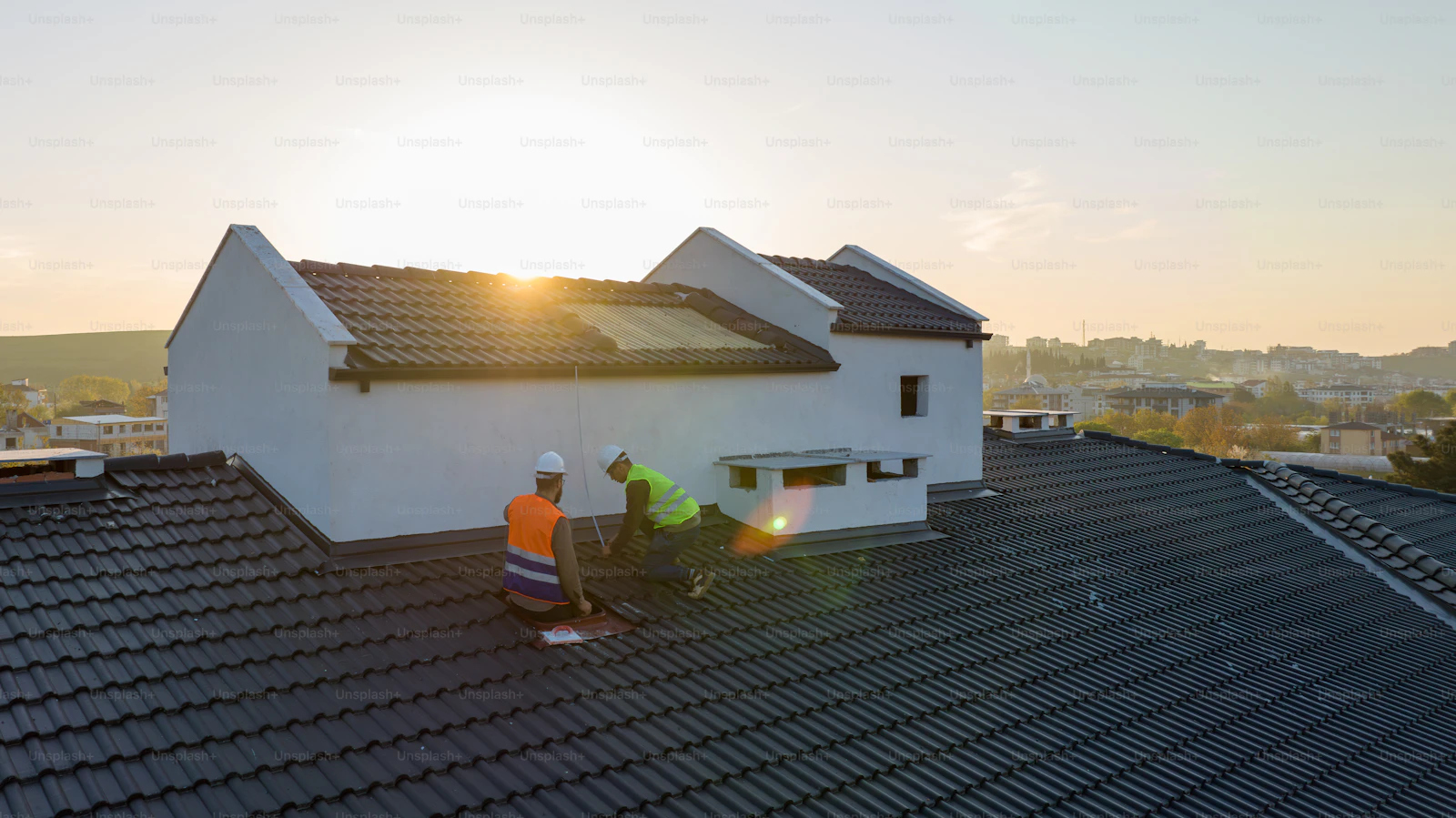 Apex Roofing installation team carrying roof panels across a scaffold.
