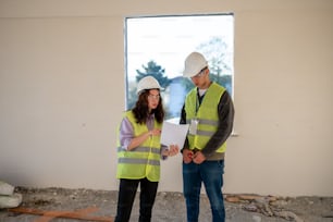 a man and a woman standing in a construction site