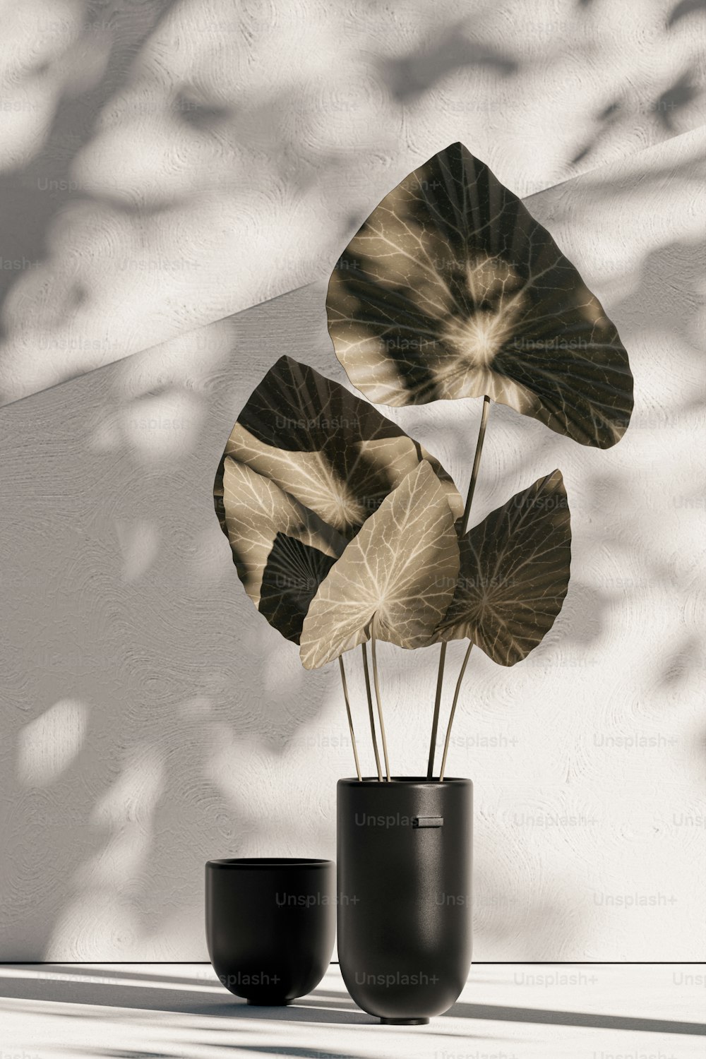 a couple of black vases sitting on top of a table