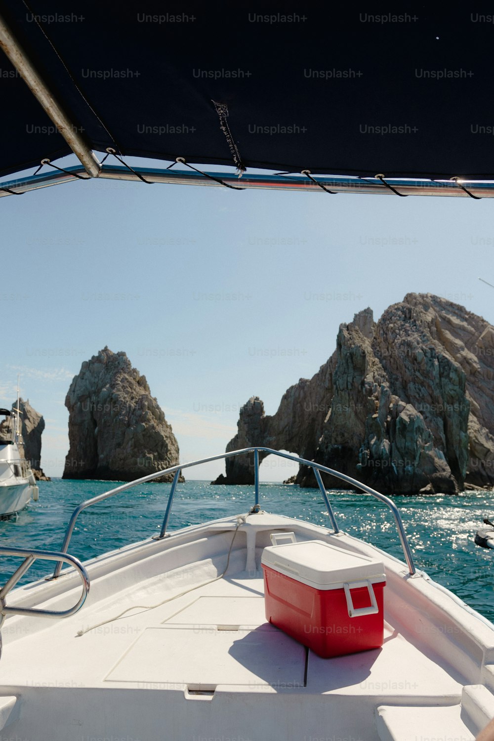 a boat in the water with rocks in the background