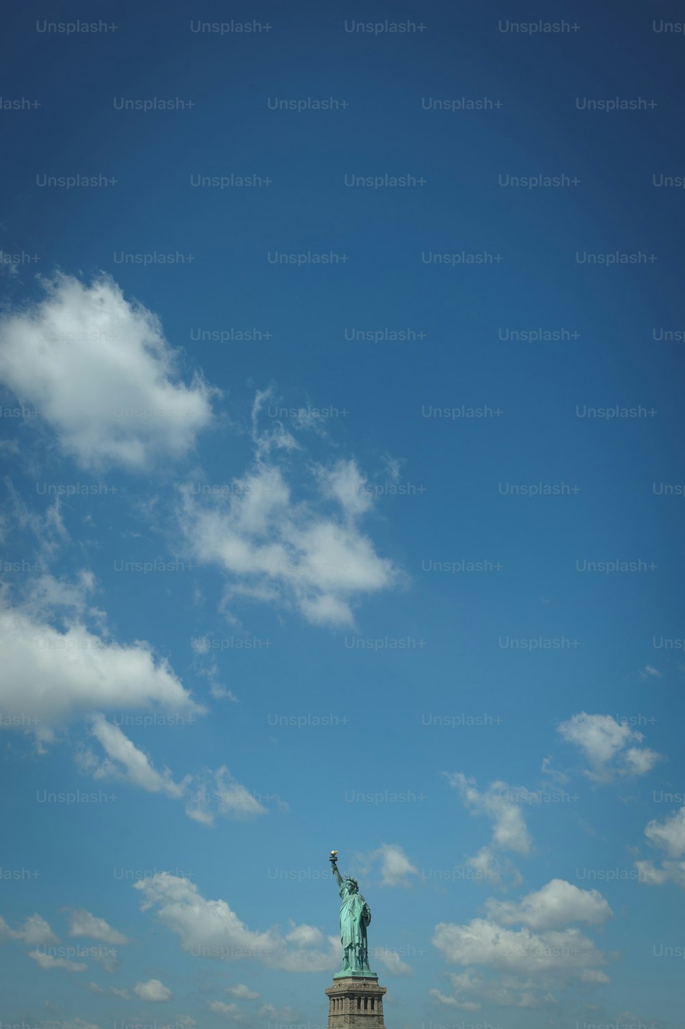 the statue of liberty is shown against a blue sky