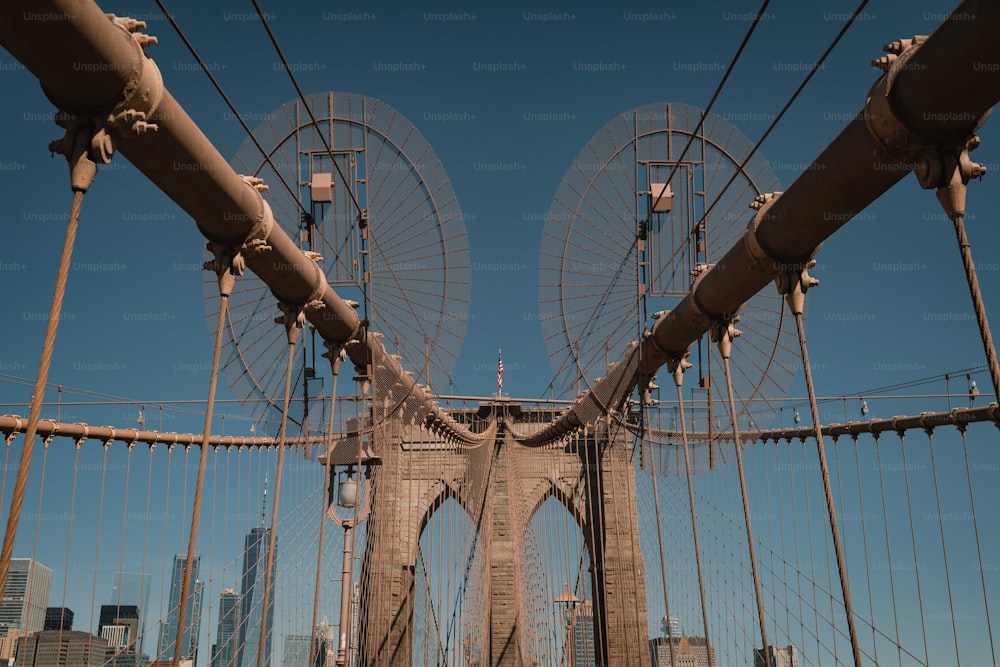 a view of a bridge with a ferris wheel in the background