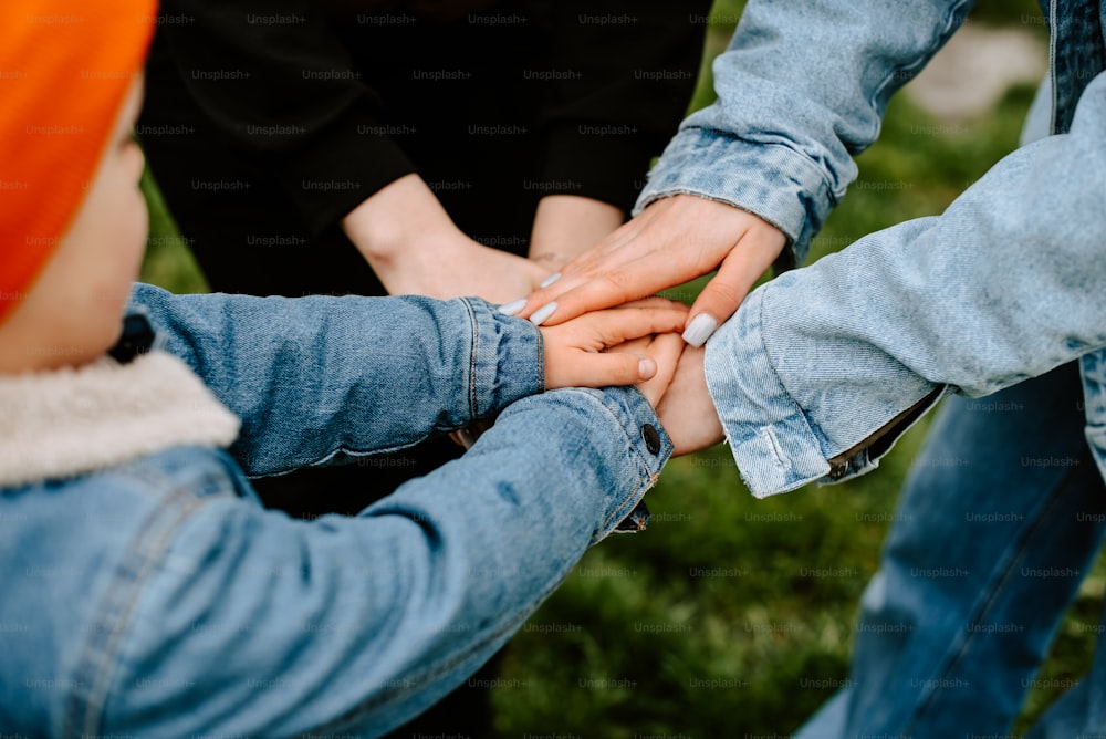 a group of people putting their hands together