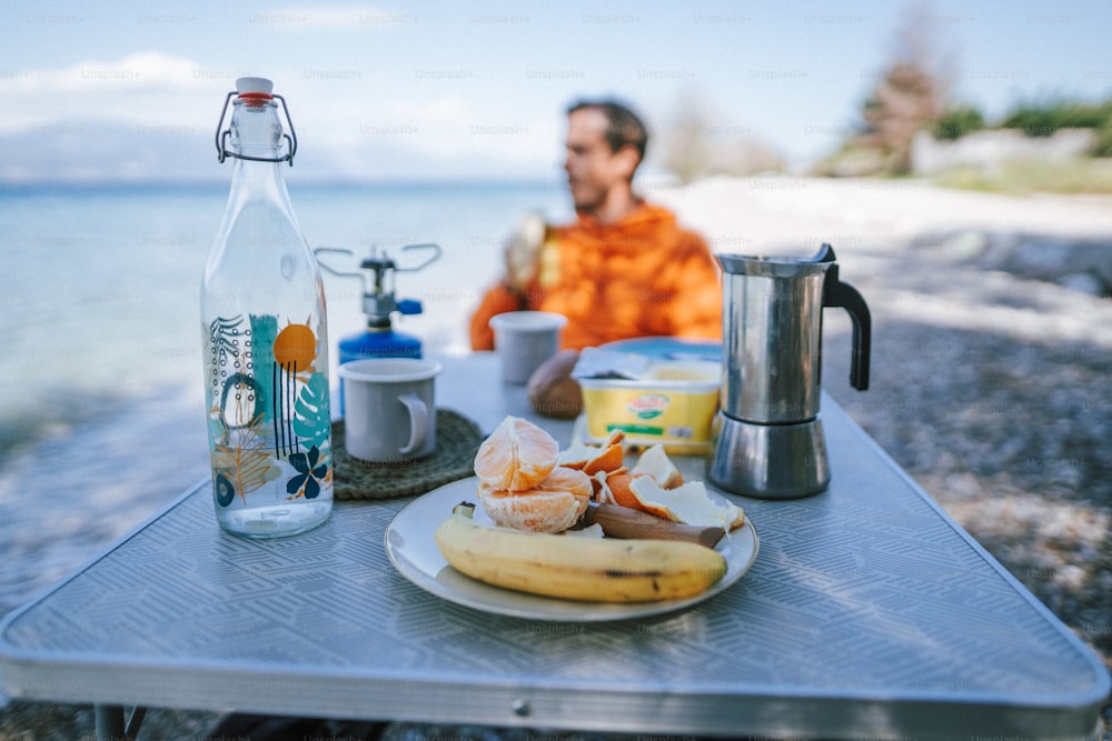 a man sitting at a table with a plate of food