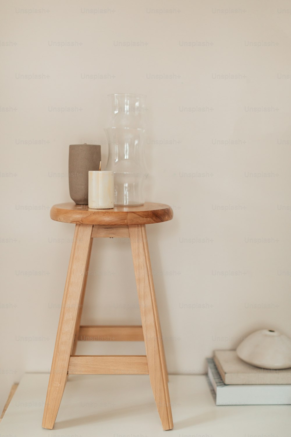 a wooden stool with a candle on top of it