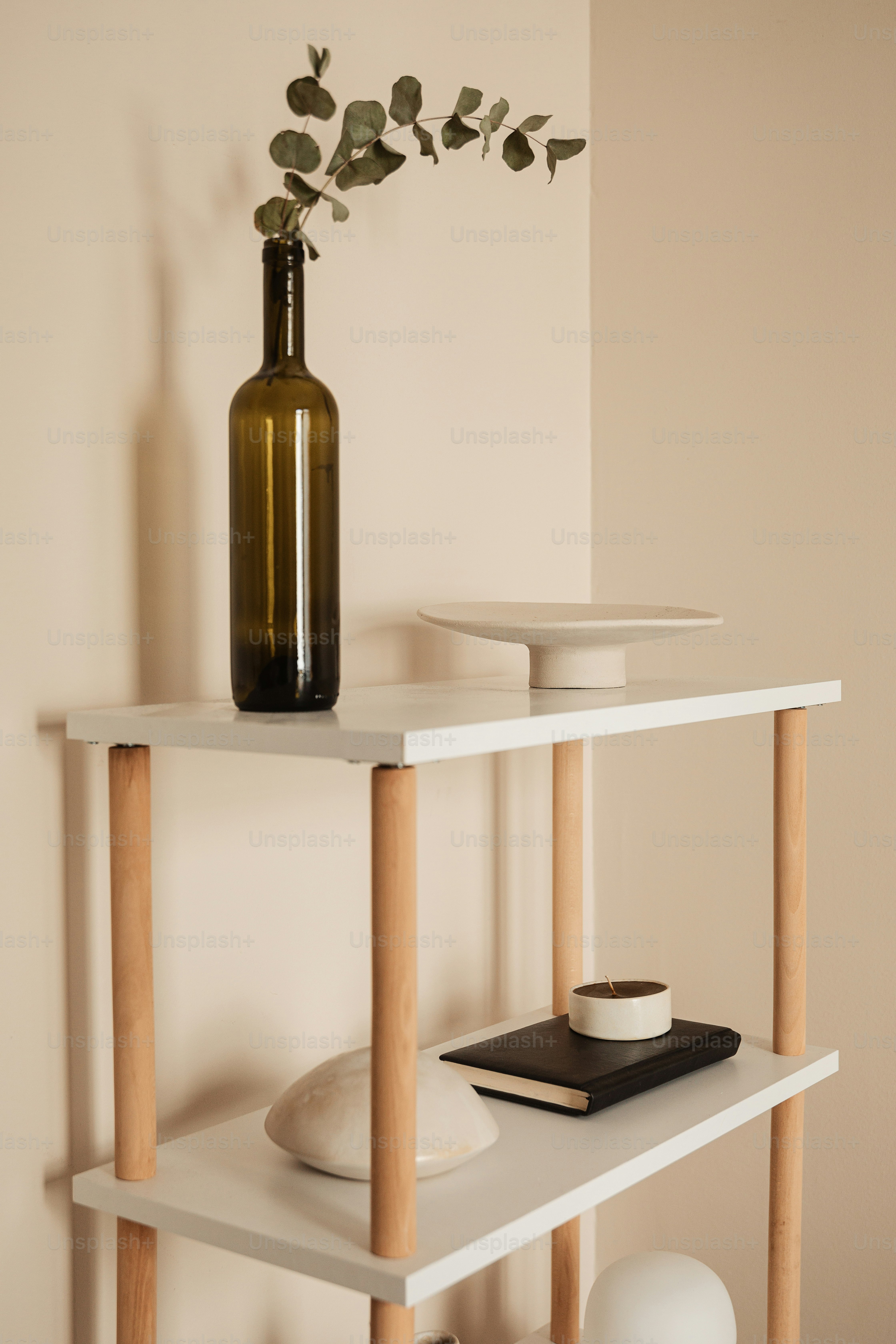 a shelf with a vase and a bowl on it