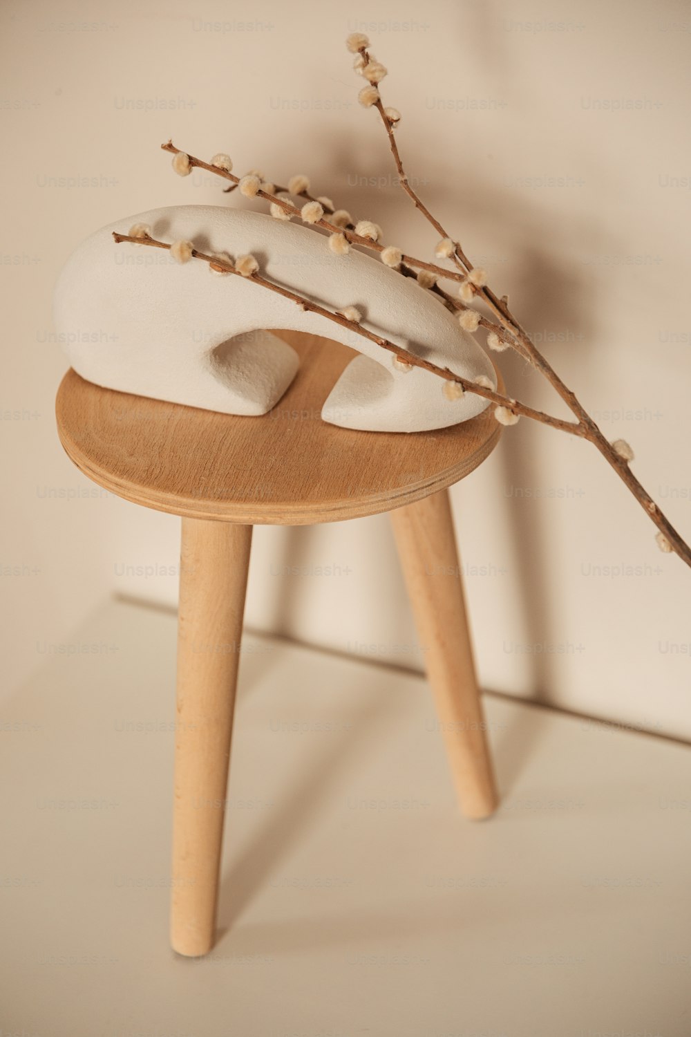 a wooden stool with a plant on top of it