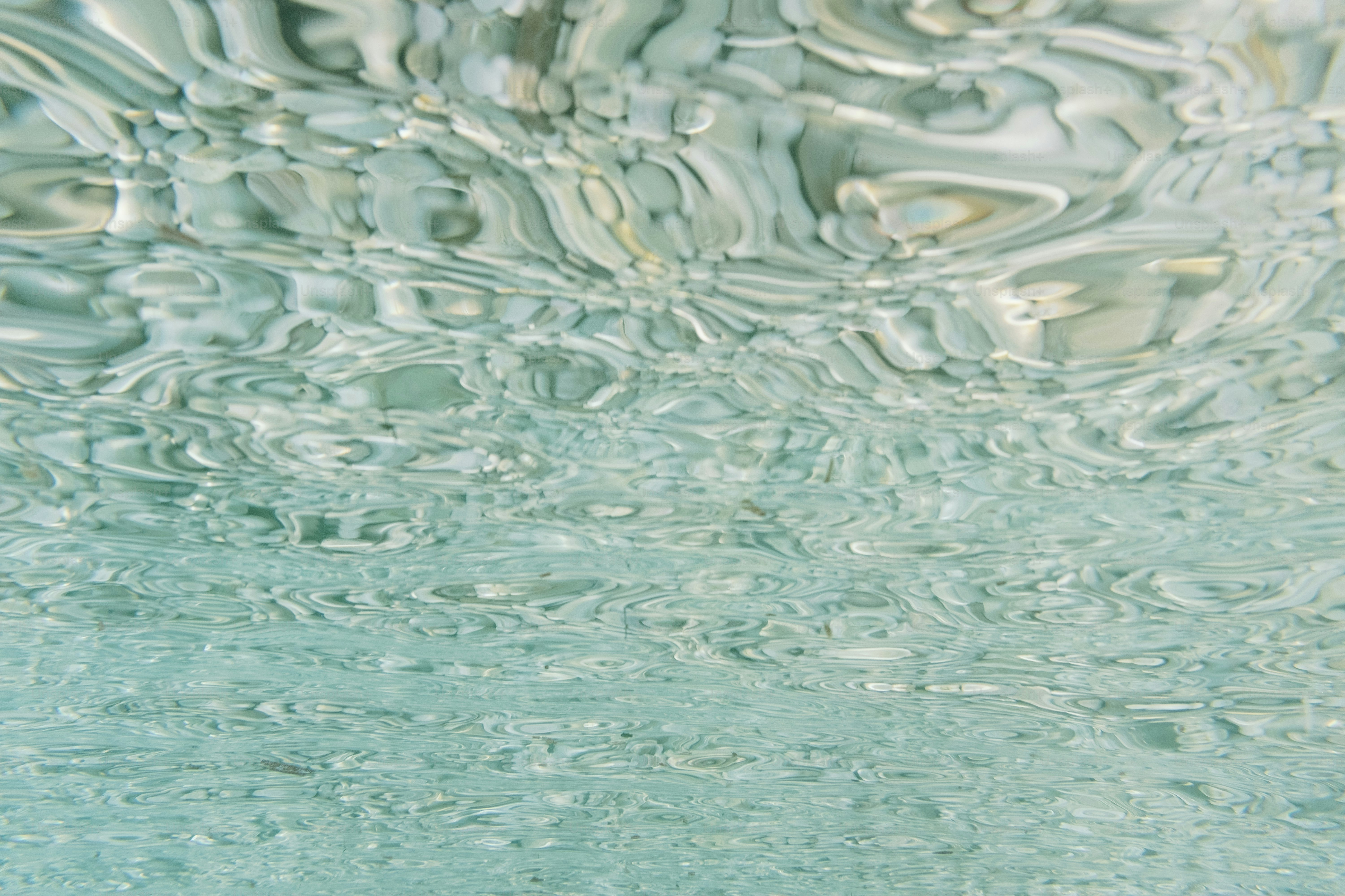 a close up of water with a sky in the background