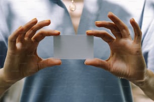 Una persona con una tarjeta blanca en sus manos