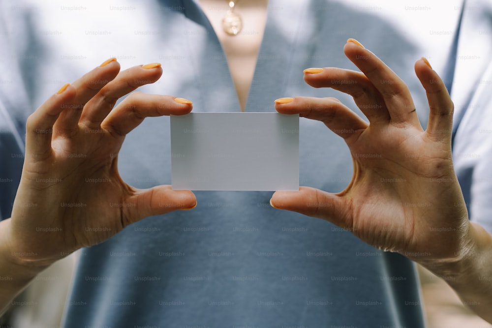 a person holding a white card in their hands