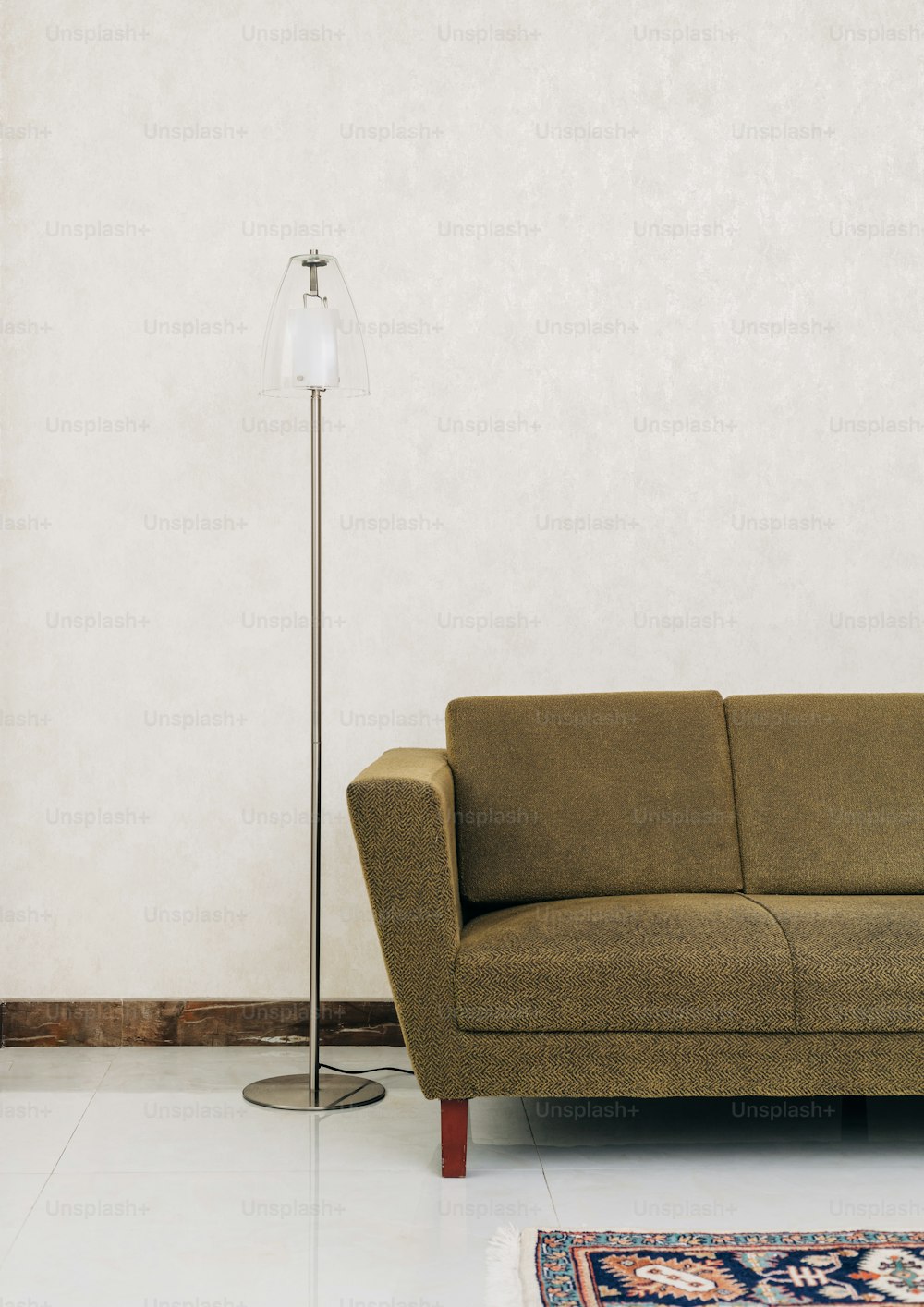 a living room with a couch and a lamp